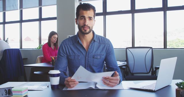 Young Professional Analyzing Documents in Modern Office - Download Free Stock Images Pikwizard.com