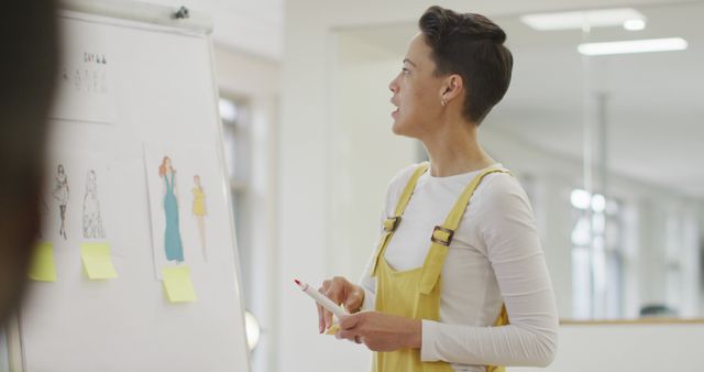 Fashion Designer Presenting New Collection Concepts on Whiteboard - Download Free Stock Images Pikwizard.com