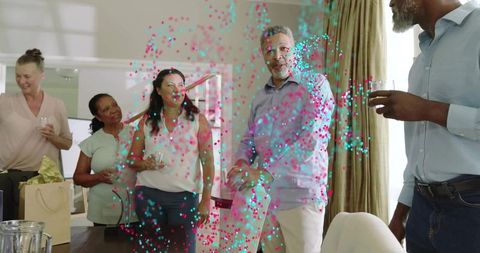 Sunlit home celebration with colorful confetti and smiling friends around dining table
