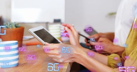 Diverse team engaging with 6g network technology in modern office