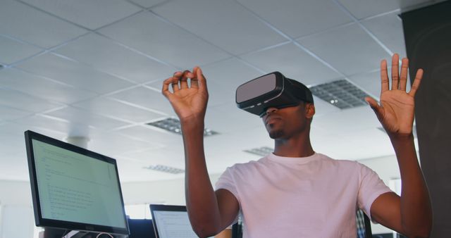 Young black male executive using virtual reality headset at desk in modern office. Young black male executive gesturing 4k