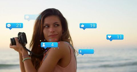 Woman Enjoying Sunset with Camera Engaged in Social Media Activity