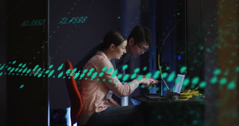 Tech Specialists Analyzing Data in Server Room