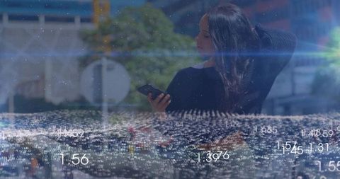 Woman holding phone and raising hand behind reflective glass with digital data overlay