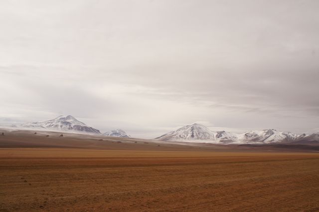 Snow-capped Mountains under Cloudy Sky in Desert Landscape - Download Free Stock Photos Pikwizard.com