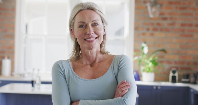 Smiling Middle-Aged Woman Standing in Bright Kitchen - Download Free Stock Images Pikwizard.com