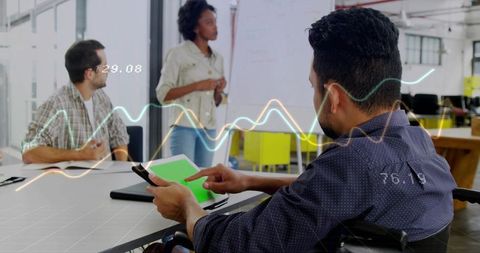 Team collaborating on tablet with real-time data overlays in bright open-plan office