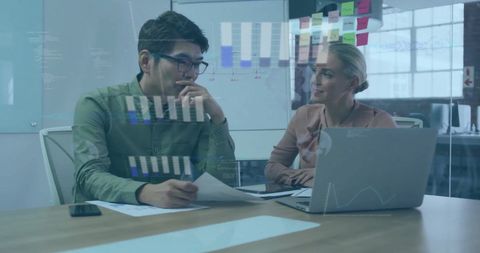 Diverse Team Collaborating on Digital Strategy with Graph Visualizations