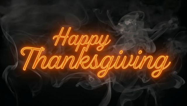 Happy thanksgiving neon script sign glowing amber tubing with smoke and dark backdrop