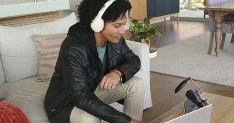 African american creator recording podcast at home with laptop and pop filter microphone
