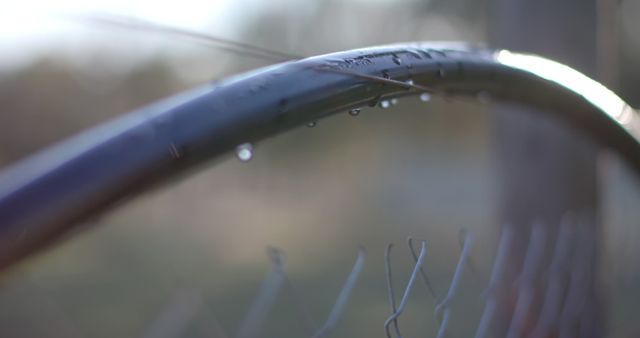 Water Droplets on Curved Metal Fence Post in Soft Focus Outdoors - Download Free Stock Images Pikwizard.com