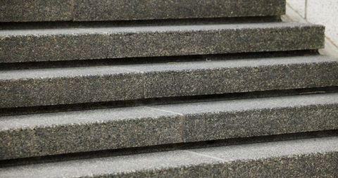Textured Granite Steps Close-Up Showing Repeating Lines and Urban Staircase Detail