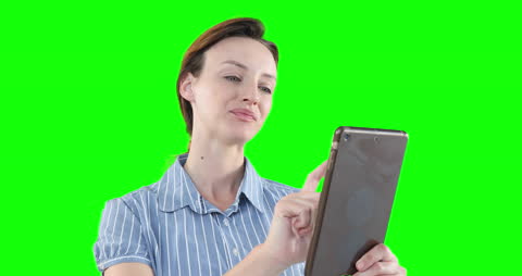 Woman Smiling While Using Tablet on Green Screen