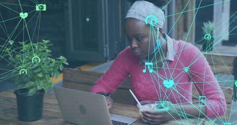African American Woman Engages with Digital Network On Laptop