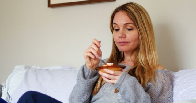 Woman Relaxing at Home Eating Dessert on Sofa - Download Free Stock Images Pikwizard.com