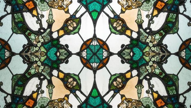 Ornate Stained Glass Filtering Light in Cathedral