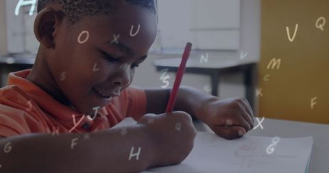 Enthusiastic young boy enjoying writing in classroom