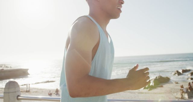 Young Man Running Along Beachfront in Sunshine - Download Free Stock Images Pikwizard.com