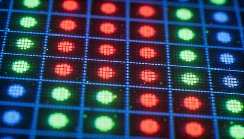 Macro magnifying rgb led pixel matrix revealing subpixel emitters, blue grid circuitry
