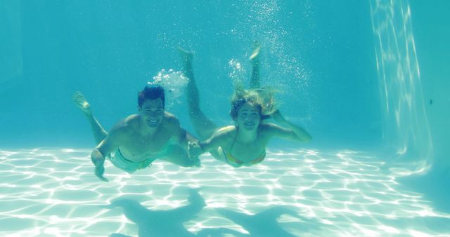 Couple Swimming Underwater in Pool Having Fun - Download Free Stock Images Pikwizard.com