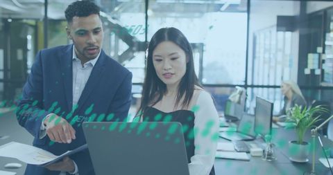 Diverse Team Analyzing Financial Data on Office Laptop