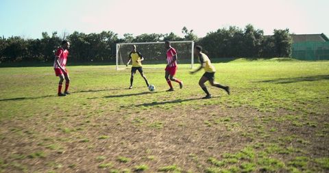 Intense Soccer Match on Sunlit Field with Diverse Players