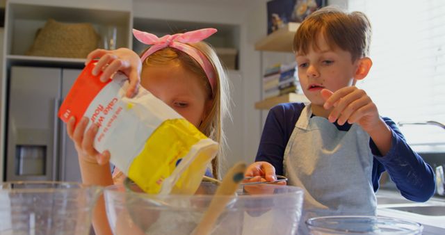 Young children baking together in a modern kitchen - Download Free Stock Images Pikwizard.com