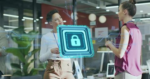 Colleagues Collaborating on Cybersecurity in Open-Plan Office