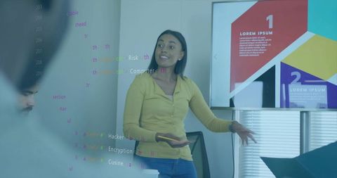 Presenter pointing at colorful infographic during collaborative tech meeting in boardroom