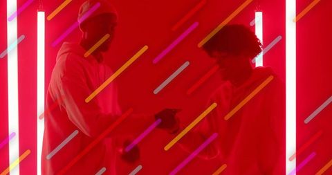 Futuristic Fist Bump among Friends in Vivid Red Neon Light