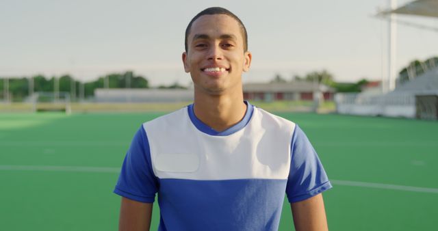 Young Man Smiling on Outdoor Sports Field During Daytime - Download Free Stock Images Pikwizard.com