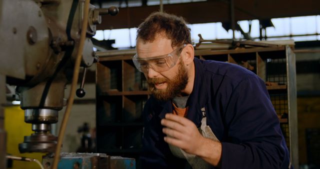 Factory Worker Operating Machinery Wearing Safety Goggles - Download Free Stock Images Pikwizard.com