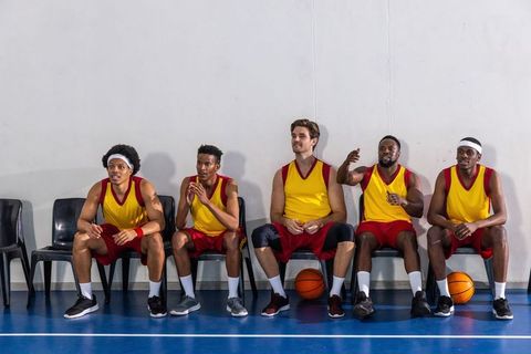 Basketball Team Bonding on Bench in Gym Environment