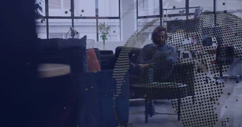 Businessman working on laptop in modern office lounge with contemporary design