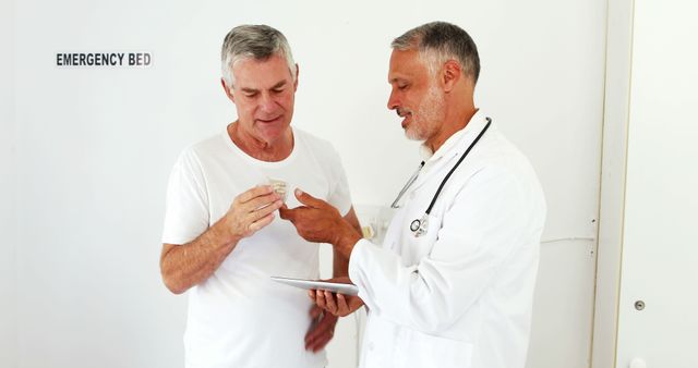 Doctor Consulting with Senior Male Patient in Hospital - Download Free Stock Images Pikwizard.com