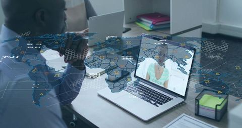 Man resting chin watching virtual meeting on laptop with global network overlay