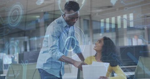 Business team collaborating in modern tech office with HUD overlay and data visualization