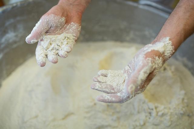 Close-up of hand mixing flour