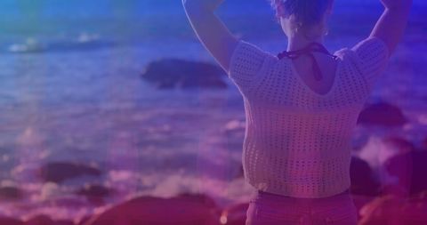 Young Woman Gazing at Ocean during Sunset