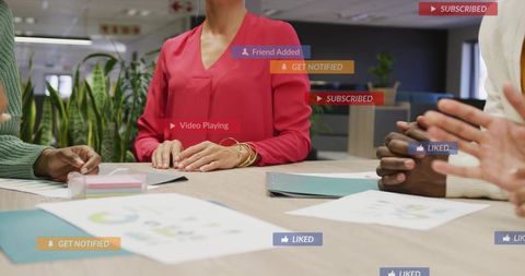 Businesswoman leading team meeting with animated social media metrics and collaboration