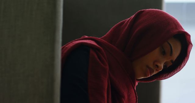 Pensive Woman With Red Hijab Lost in Thought Indoors - Download Free Stock Images Pikwizard.com