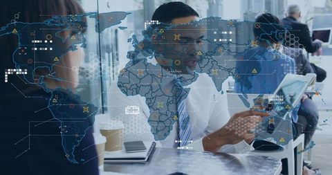 Businessman pointing at tablet with global data overlay, collaborating on digital interface