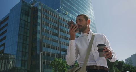 Businessman Communicating with Smartphone on City Street