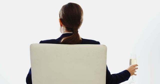 Confident Businesswoman Relaxing in Chair Holding Glass of Champagne - Download Free Stock Images Pikwizard.com