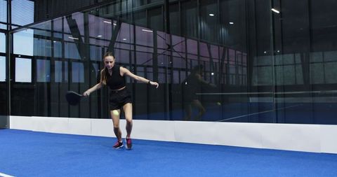 Female Athlete Playing Padel on Indoor Court