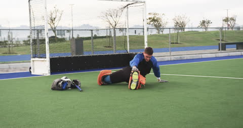 Hockey Player Stretching on Field for Training Session