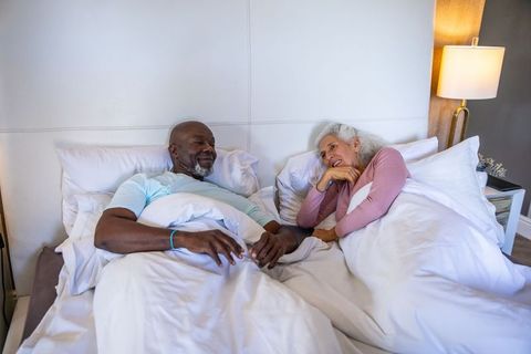 Senior Couple Relaxing in Bedroom with Cozy Atmosphere