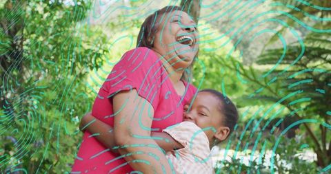 Laughing mother hugging child in sunlit garden with teal swirl graphic for family wellness