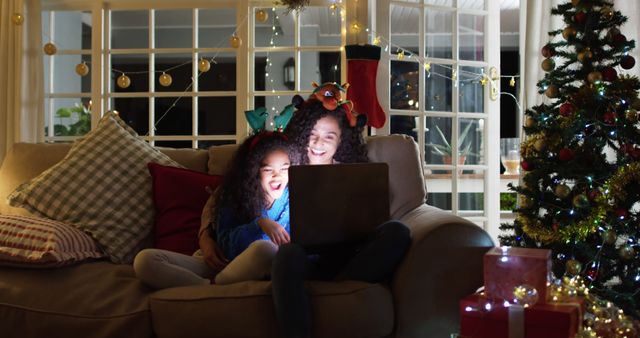 Mother and Daughter Enjoying Christmas Evening Together With Laptop - Download Free Stock Images Pikwizard.com