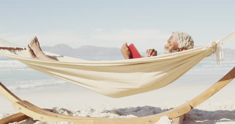 Senior Man Enjoying Relaxing Beach Hammock Day